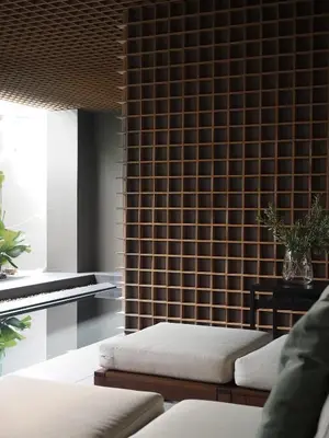 a living room with a couch and a piano at Norma Hotel Sathorn in Bangkok