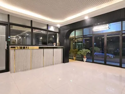 a lobby of a building with large glass windows at Floton Bangkok Hotel in Bangkok
