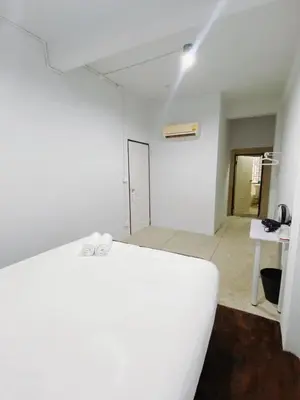 a white room with a white couch and a table at xx BAO The Giant Swing - Sao Chingcha - เบา ศาลเจ้าพ่อเสือ เสาชิงช้า in Bangkok