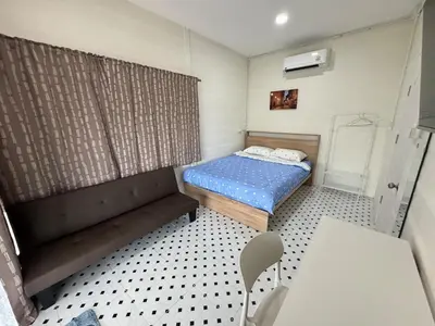a small room with a bed and a couch at DD Canel in Bangkok