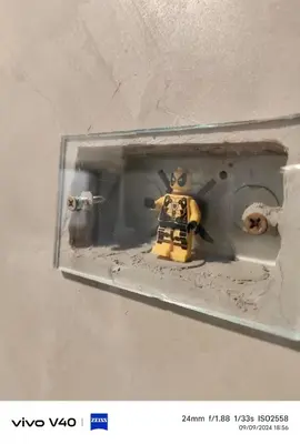 a lego toy in a lightswitch with a toy cow at Hoft Hotel Ramkhamhaeng24 in Sathani Khlong Tan