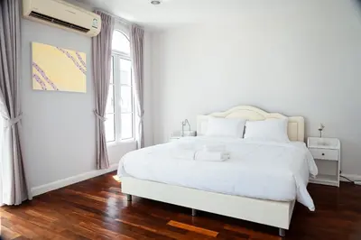 a white bedroom with a white bed and a window at 3 Bedroom Spacious Home in Downtown Bangkok Near MRT BTS Asok Station in Bangkok
