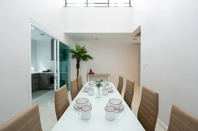 a dining room with a white table and chairs at 3 Bedroom Spacious Home in Downtown Bangkok Near MRT BTS Asok Station in Bangkok