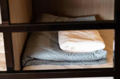 a couple of pillows sitting on a shelf at Orange Lodge in Bangkok