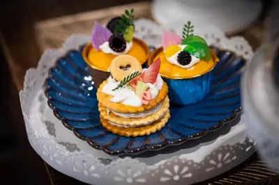 a plate with three cupcakes on top at Orange Lodge in Bangkok
