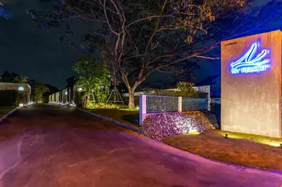 a sign for a hospital at night at NY Resort Nonthaburi in Nonthaburi