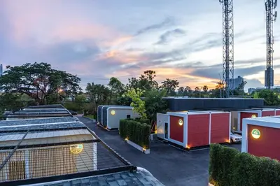 a row of tiny houses in a parking lot at NY Resort Nonthaburi in Nonthaburi