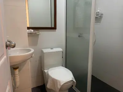 a bathroom with a toilet and a sink and a shower at M3 Bangkok Bake & Bed in Bangkok