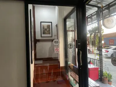 a door to a building with a no parking sign on it at M3 Bangkok Bake & Bed in Bangkok