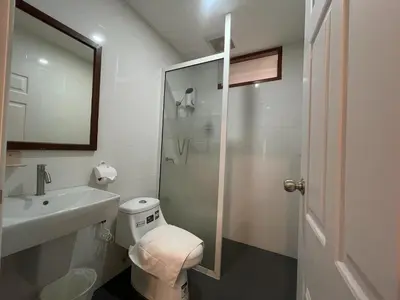 a bathroom with a toilet and a sink and a shower at M3 Bangkok Bake & Bed in Bangkok