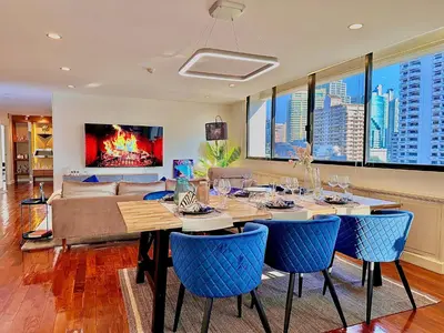 a dining room with a table and blue chairs at Luxury 3 bedrooms in the heart of the city in Bangkok