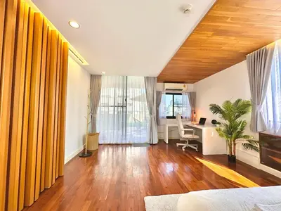 a living room with yellow curtains and a desk at Luxury 3 bedrooms in the heart of the city in Bangkok