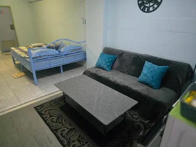 a living room with a couch and a table at Beautiful Studio 107 Apartment with nice living room with WiFi in Bangkok