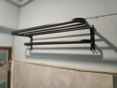 a black metal shelf on a wall at Beautiful Studio 107 Apartment with nice living room with WiFi in Bangkok