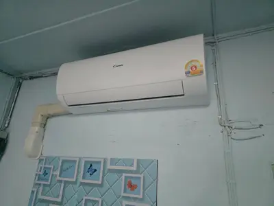 a white appliance on the wall of a bathroom at Beautiful Studio 107 Apartment with nice living room with WiFi in Bangkok