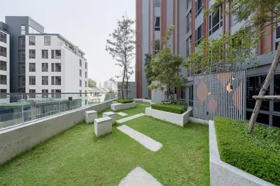 a garden on the roof of a building at 1BR Apt - Pool, Gym, Rooftop, BTS, Coworking Space - 10 min Nana Plaza - Central - New Building - 24 7 Security in Bangkok