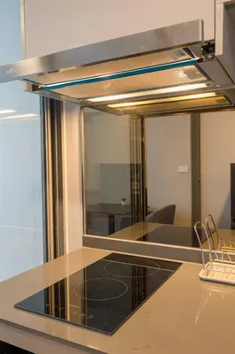 a kitchen with a large mirror over a counter at 1BR Apt - Pool, Gym, Rooftop, BTS, Coworking Space - 10 min Nana Plaza - Central - New Building - 24 7 Security in Bangkok