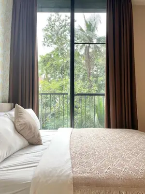 a bedroom with a bed and a large window at Phrom Phong Top 1BD pool,gym,park and mall BTS in Khlong Toei