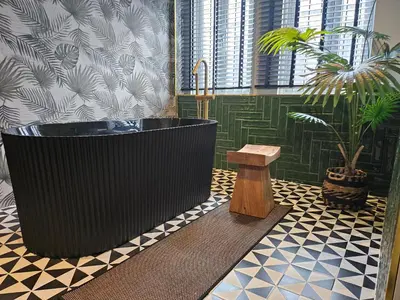 a bathroom with a large tub and a potted plant at Soho Heritage House China Town Bangkok in Bangkok