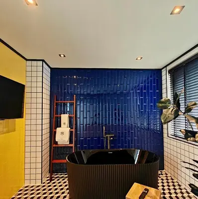 a bathroom with a sink and a blue wall at Soho Heritage House China Town Bangkok in Bangkok