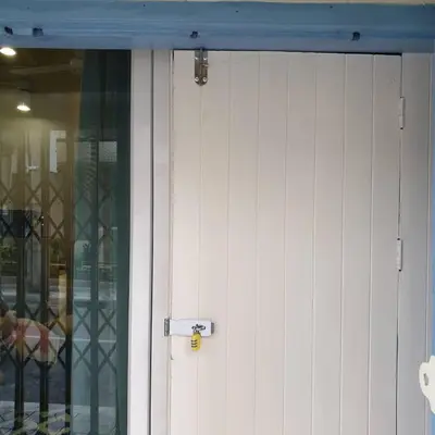 a white garage door with a silver handle on it at BaanBaan - Cozy home 5pax, 5min BTS, Boat, old town explore in Bangkok