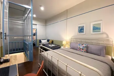 a small bedroom with a bed and a desk at BaanBaan - Cozy home 5pax, 5min BTS, Boat, old town explore in Bangkok