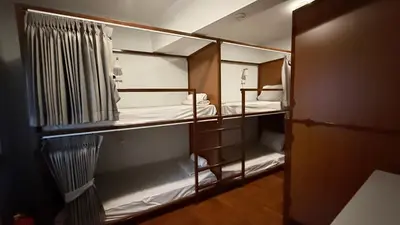 a room with some bunk beds in a room at Delight Hostel at Khao San in Bangkok
