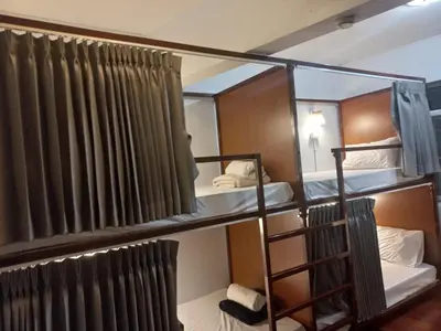a room with two bunk beds and a mirror at Delight Hostel at Khao San in Bangkok