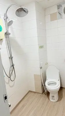 a bathroom with a toilet and a shower at Delight Hostel at Khao San in Bangkok