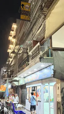 a man is standing outside of a restaurant at Delight Hostel at Khao San in Bangkok