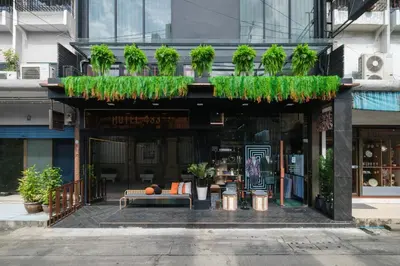a building with a bench in front of a store at Hotel 433 - Asoke Sukhumvit in Bangkok