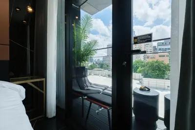 a balcony with a bench with a plant on it at Hotel 433 - Asoke Sukhumvit in Bangkok
