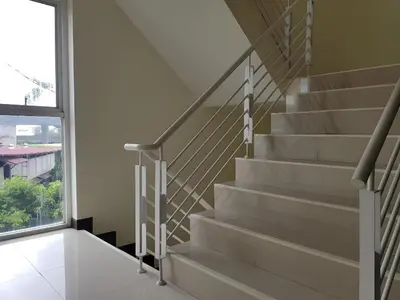 a staircase in a house with a window at Collection O VResotel in Nonthaburi