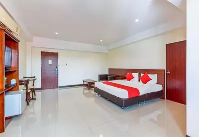 a hotel room with a bed and a kitchen at Collection O VResotel in Nonthaburi