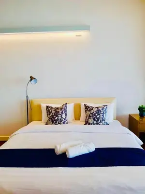 a bedroom with a large white bed with pillows at Canal Villa on Onnut Road, near Bts Onnut, Bangkok in Amphoe Phra Khanong
