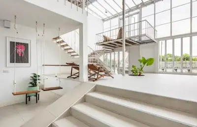 a white room with stairs and a stair case at Canal Villa on Onnut Road, near Bts Onnut, Bangkok in Amphoe Phra Khanong