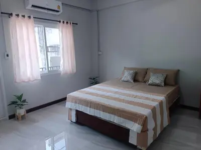 a bedroom with a bed and a window at The Little home in Ban Khlong Mae Nam Bon