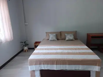 a bedroom with a large bed in a room at The Little home in Ban Khlong Mae Nam Bon