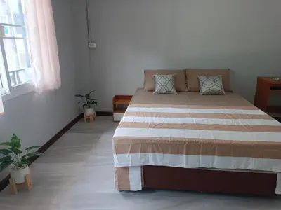 a bedroom with a large bed in a room at The little home in Bang Mote
