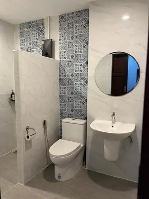 a bathroom with a toilet and a sink and a mirror at Baan Saen Saran residence in Sathani Bang Ramat