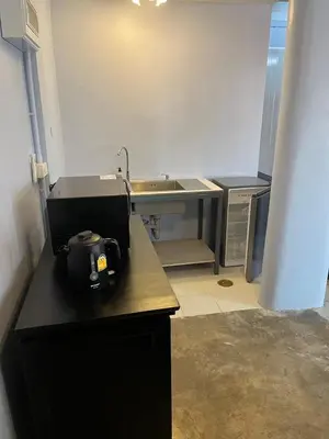 a kitchen with a sink and a counter top at Baan Saen Saran residence in Sathani Bang Ramat