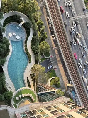 an aerial view of a building with a swimming pool at 1 bedroom condo, next to BTS Talat Phlu, 0 meters, near Iconsiam, monthly room available in Bangkok