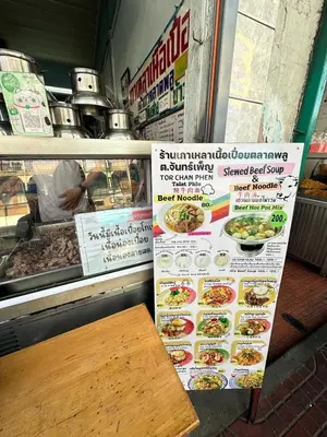 a restaurant with a bench in front of a counter at 1 bedroom condo, next to BTS Talat Phlu, 0 meters, near Iconsiam, monthly room available in Bangkok