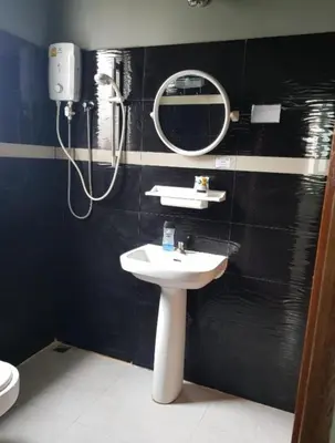a bathroom with a sink and a shower at Jatujak Bangkok guesthouse R3 in Sathani Bang Su