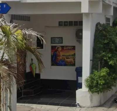 a building with a painting on the side of it at Jatujak Bangkok guesthouse R3 in Sathani Bang Su