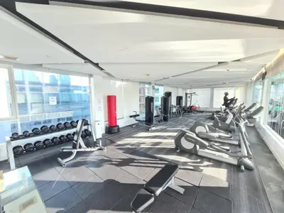 a gym with a lot of treadmills and machines at Comfort Zone in Bangkok