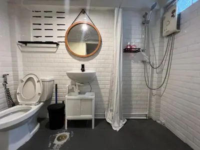 a white bathroom with a sink and a mirror at 3 bedrooms 2 bathroom's in Bang Su