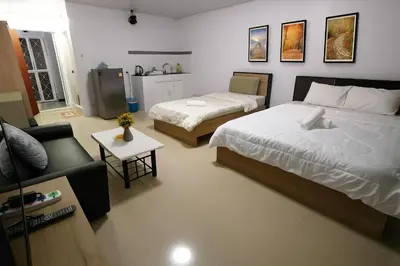 a living room with two beds and a couch at impact เมืองทองธานี ห้องเช่ารายวัน pupular condo T9 C5 C4 C9 T8 in Thung Si Kan
