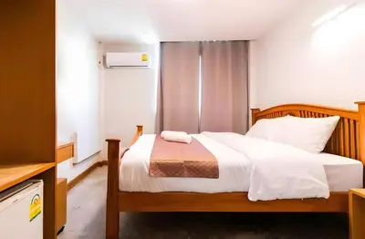 a bedroom with a bed with white sheets at XX GO INN Khaosan - ตรอกข้าวสาร กรุงเทพ in Bangkok