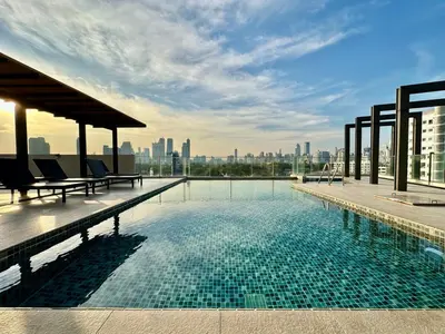 a swimming pool on the roof of a building at Bright & Spacious Apartment - Asoke in Bangkok